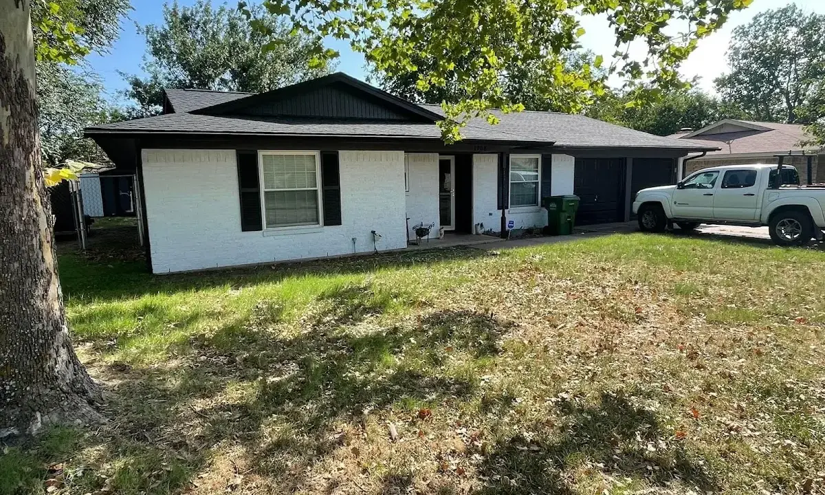 Professional roofing crew working on a residential roof in Addison